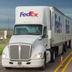 A-white-FedEx-Freight-tractor-pulling-two-FedEx-pup-trailers.jpg