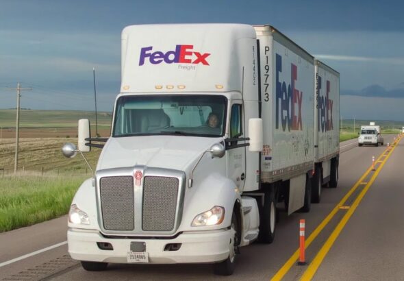 A-white-FedEx-Freight-tractor-pulling-two-FedEx-pup-trailers.jpg