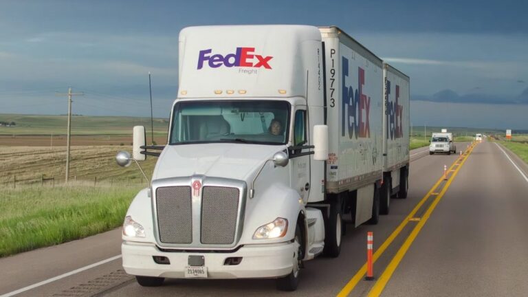 A-white-FedEx-Freight-tractor-pulling-two-FedEx-pup-trailers.jpg